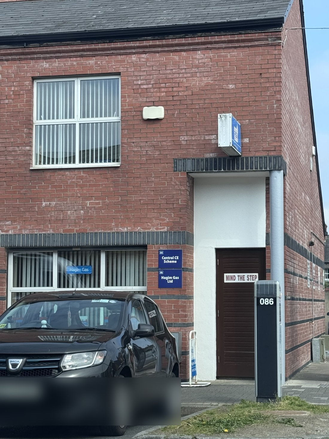 The Hagim Gas office at Partnership Court, Dundalk: a red-brick building with the business's signs beside the door