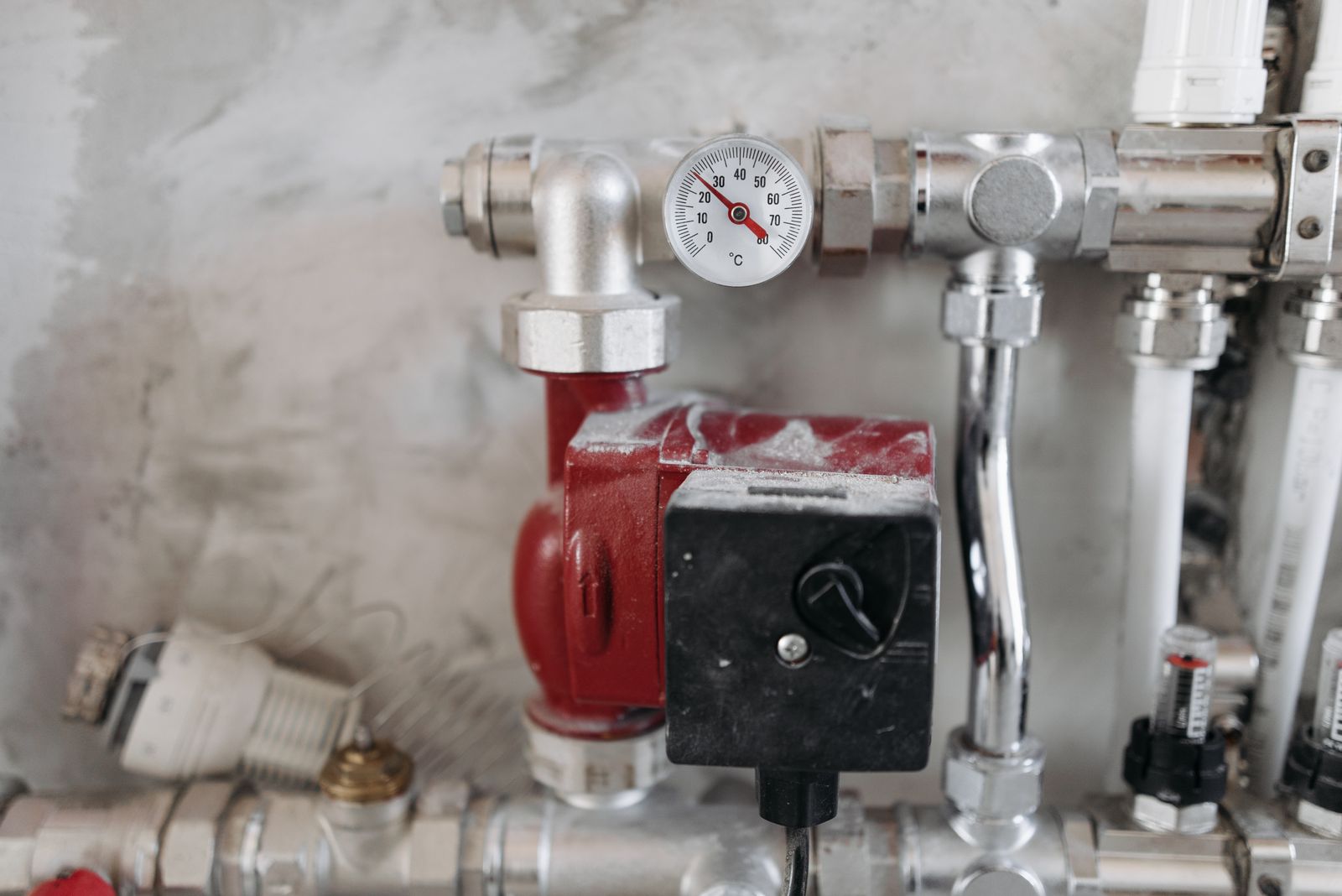 Sample image of heating pipework with a temperature gauge and a circulating pump